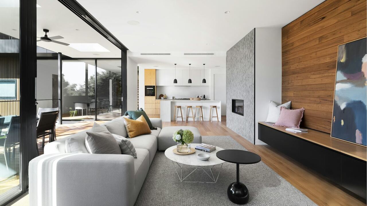 Coastal Florida living room with a light linen sofa facing tall glass doors in soft morning sun